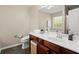 Bathroom featuring a single sink vanity with wood cabinetry, tile floors, and stylish decor at 2125 Mina Lane Dr, Buford, GA 30518