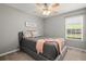 This bedroom boasts natural light, ceiling fan and wall decor at 2125 Mina Lane Dr, Buford, GA 30518