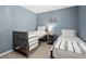 Blue bedroom featuring two twin beds, a small lamp, and wall decor at 2125 Mina Lane Dr, Buford, GA 30518