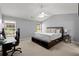 Bedroom boasts a large bed, ceiling fan, and carpeted floors at 2125 Mina Lane Dr, Buford, GA 30518