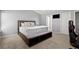 This bedroom offers a carpet floor and a large bed with unique headboard and a seating area at 2125 Mina Lane Dr, Buford, GA 30518