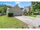 Inviting home with a two-car garage, lush lawn, and a beautifully landscaped yard at 2125 Mina Lane Dr, Buford, GA 30518