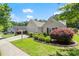 Beautiful home with manicured front lawn, complemented by vibrant shrubs, and a two car garage at 2125 Mina Lane Dr, Buford, GA 30518