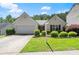 Charming one-story home with lush landscaping, inviting curb appeal, and a two car garage at 2125 Mina Lane Dr, Buford, GA 30518