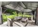 Relaxing outdoor gazebo with comfortable seating, drapes and backyard view at 2125 Mina Lane Dr, Buford, GA 30518