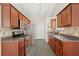 Galley-style kitchen with stainless steel appliances and dark wood cabinets at 2125 Mina Lane Dr, Buford, GA 30518