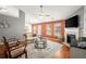 Bright living room boasts hardwood floors, fireplace, modern ceiling fan, and neutral color scheme at 2125 Mina Lane Dr, Buford, GA 30518