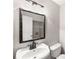 Cozy half bath featuring a unique mirror and fixtures, plus a view of the laundry area at 2340 Beaver Ruin Rd # 68, Norcross, GA 30071