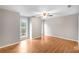 Bright bedroom featuring wood flooring, ceiling fan, and neutral paint at 2340 Beaver Ruin Rd # 68, Norcross, GA 30071