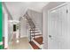 Inviting entryway showcasing wood stairs with metal railing and beige tile flooring at 2340 Beaver Ruin Rd # 68, Norcross, GA 30071
