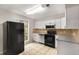 Well-lit kitchen with stainless steel appliances and a view of the backyard at 2340 Beaver Ruin Rd # 68, Norcross, GA 30071