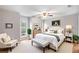 Serene primary bedroom featuring a ceiling fan, hardwood floors, and comfortable furnishings at 2340 Beaver Ruin Rd # 68, Norcross, GA 30071