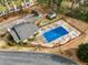 Aerial view of a community pool with a blue cover and wrought iron fencing at 2340 Beaver Ruin Rd # 68, Norcross, GA 30071