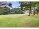 Expansive backyard with well-maintained lawn, mature trees, and a charming gazebo at 2835 Channing Way, Cumming, GA 30040