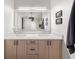This bathroom has a double vanity with framed mirrors, ample cabinets, and neutral paint at 2835 Channing Way, Cumming, GA 30040