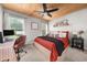 This bedroom has a wood plank ceiling, home office desk, and an area rug at 2835 Channing Way, Cumming, GA 30040