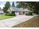 Traditional home with a long concrete driveway, complemented by green landscaping at 2835 Channing Way, Cumming, GA 30040