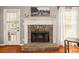 A stone fireplace with white mantel, flanked by a door and a window with white curtains at 2835 Channing Way, Cumming, GA 30040