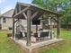 Outdoor gazebo with seating, a mounted tv, and a heater on a concrete patio at 2835 Channing Way, Cumming, GA 30040