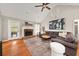 Cozy living area featuring a vaulted ceiling, stone fireplace, and neutral decor at 2835 Channing Way, Cumming, GA 30040