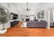 Open living room with hardwood floors, vaulted ceiling, stone fireplace, and abundant light at 2835 Channing Way, Cumming, GA 30040