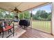 Relaxing screened-in porch with ceiling fan, barbecue, and patio furniture at 2835 Channing Way, Cumming, GA 30040