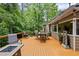 Expansive back deck with outdoor seating, a fire pit, and views of the lush surroundings at 5107 Old Chestnut Ct, Woodstock, GA 30188
