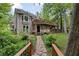 Beautiful backyard with a stone pathway, mature trees, and a multi-level wooden deck at 5107 Old Chestnut Ct, Woodstock, GA 30188
