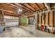 Unfinished basement with two car garage door and visible ceiling beams, offering storage and customization at 5107 Old Chestnut Ct, Woodstock, GA 30188