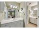 Spacious bathroom with white cabinets and a large mirror overlooking the bedroom at 5107 Old Chestnut Ct, Woodstock, GA 30188