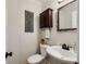 Cozy powder room featuring a pedestal sink, dark wood cabinet, and decorative mirror at 5107 Old Chestnut Ct, Woodstock, GA 30188