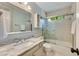 Bathroom features a bathtub and shower combo, white vanity and granite countertops at 5107 Old Chestnut Ct, Woodstock, GA 30188