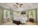 Bright bedroom features a tray ceiling, neutral walls, and a spacious king size bed with matching side tables at 5107 Old Chestnut Ct, Woodstock, GA 30188