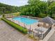Community pool with covered picnic tables and lounge chairs in a fenced area at 5107 Old Chestnut Ct, Woodstock, GA 30188