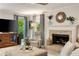 Inviting living room with fireplace, neutral paint, and windows offering ample natural light at 5107 Old Chestnut Ct, Woodstock, GA 30188