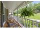 Relaxing front porch with comfortable seating and a hanging fern basket at 5107 Old Chestnut Ct, Woodstock, GA 30188