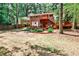 View of the backyard with brick home, wooden deck, and manicured garden at 1082 Greenbriar Cir, Decatur, GA 30033