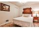 This quaint bedroom has a decorative headboard, unique flooring and a picture hanging on the wall at 1082 Greenbriar Cir, Decatur, GA 30033