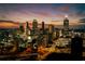 Striking city skyline view showcasing illuminated high-rise buildings against a vibrant twilight sky at 1082 Greenbriar Cir, Decatur, GA 30033
