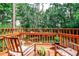 An exterior view of a deck with chairs surrounded by a lush green forest in the background at 1082 Greenbriar Cir, Decatur, GA 30033