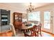 Cozy dining area with hardwood floors, natural light, a china cabinet, and a view of the backyard at 1082 Greenbriar Cir, Decatur, GA 30033