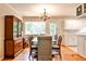 Cozy dining room with hardwood floors, chandelier lighting, and a large window showcasing the outdoor scenery at 1082 Greenbriar Cir, Decatur, GA 30033