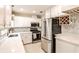 Bright kitchen featuring stainless steel appliances, marble countertops, and white cabinetry at 1082 Greenbriar Cir, Decatur, GA 30033
