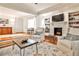 Spacious living area with hardwood floors, fireplace, built-in shelving, and seamless flow into dining area at 1082 Greenbriar Cir, Decatur, GA 30033