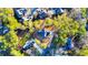 Aerial view of a dark roof home, surrounded by mature trees, lawn, and neighboring homes at 110 Randomwood Way, Alpharetta, GA 30022