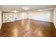 Open basement area featuring wood-look tile flooring, built-in shelving, and convenient access doors at 110 Randomwood Way, Alpharetta, GA 30022