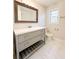 Bathroom features a gray vanity with marble top, white marble flooring, and natural light from a window at 110 Randomwood Way, Alpharetta, GA 30022