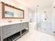 Elegant bathroom featuring double vanity, soaking tub, and glass-enclosed shower with white subway tiles at 110 Randomwood Way, Alpharetta, GA 30022