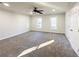 Large bedroom with neutral carpet, trim, ceiling fan, and natural light from the surrounding windows at 110 Randomwood Way, Alpharetta, GA 30022