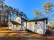 Back of home with covered porch and trees surrounding the property at 110 Randomwood Way, Alpharetta, GA 30022
